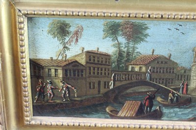 Lot 1173 - Venetian school, 17th century, pair of oils on canvas - canal scene with 
harlequins and horsemen at a bridge, both 37cm x 11cm in gilt frames (2)