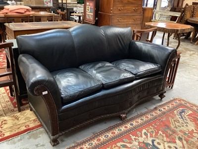 Lot 1312 - Edwardian black leather upholstered sofa and matching armchair 
with mahogany frame on claw and ball feet.