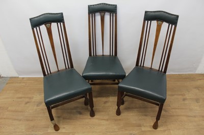 Lot 1316 - Three Arts & Crafts oak and pewter inlaid dining chairs in the manner of Charles Rennie Macintosh