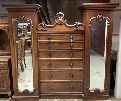 Lot 1333 - William IV mahogany wardrobe with mother of pearl inlaid 
handles, six central graduated drawers flanked by two hanging 
cupboards with mirror doors.