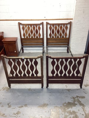 Lot 1326 - Pair of Edwardian Arts & Crafts single bedsteads, in the manner 
of Liberty’s