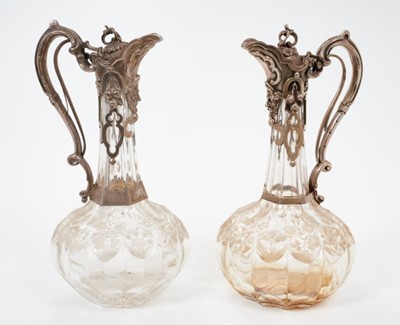 Lot 213 - Near pair Victorian  Cut glass claret jugs of onion form, with silver mounts.