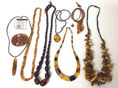 Lot 149 - Group amber bead necklaces and pendants including a simulated cherry amber necklace