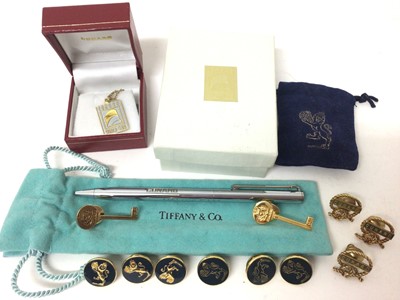 Lot 150 - Two Tiffany & Co silver gilt Cunard key shaped pins, other Cunard pins, Cunard World Club silver gilt pendant on gold plated chain and Tiffany & Co Cunard pen in pouch