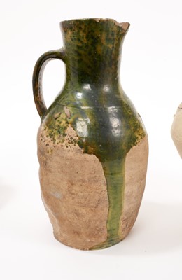 Lot 11 - Two 15th/16th century German salt-glazed stoneware mugs with thumbed footrims, together with a stoneware jug and flask probably of similar age, the largest measuring 26cm high (4)