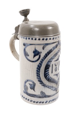 Lot 12 - A German Westerwald stoneware tankard, dated 1814, decorated with incised foliate patterns, pewter lid, total height 25.5cm