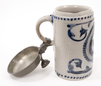 Lot 12 - A German Westerwald stoneware tankard, dated 1814, decorated with incised foliate patterns, pewter lid, total height 25.5cm