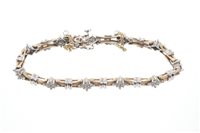 Lot 483 - White and yellow gold diamond bracelet with...