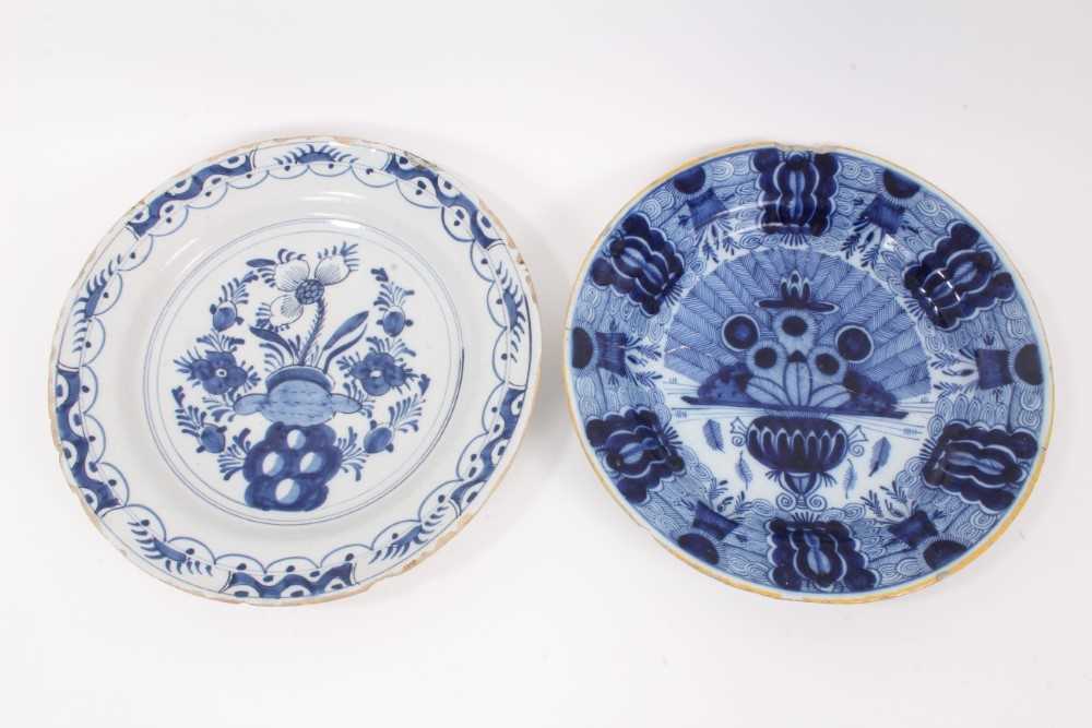 Lot 14 - Two 18th century blue and white Dutch delftware dishes, one painted with the Peacock pattern, the other with flowers, 34.5cm and 36cm diameter