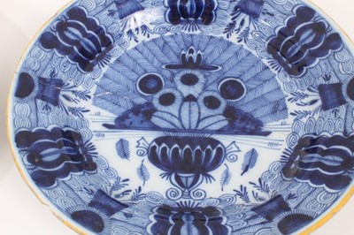 Lot 14 - Two 18th century blue and white Dutch delftware dishes, one painted with the Peacock pattern, the other with flowers, 34.5cm and 36cm diameter