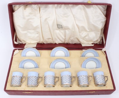 Lot 145 - Set of six Aynsley blue coffee cans in pierced silver cup mounts (Sheffield 1917) and six matching saucers, in fitted cased retailed by Harrods, London