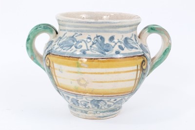 Lot 27 - An unusual Italian maiolica twin-handled pot, with blank scrollwork cartouche, probably an apothecary jar, 11cm high