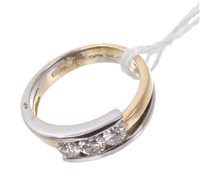 Lot 493 - Contemporary diamond three stone crossover...