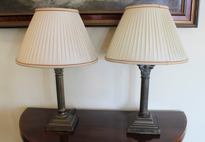 Lot 1247 - Pair of Victorian-style brass Corinthian table lamps on stepped square bases, with matching silk shades, 56cm high overall