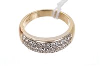 Lot 495 - Diamond set band ring with pavé set brilliant...