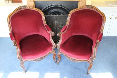 Lot 1249 - Pair of Victorian mahogany framed armchairs with carved scroll show frames, red velvet upholstery, on carved cabriole legs