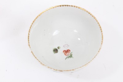 Lot 72 - A Bristol tea bowl and saucer, painted with flowers and fruits, circa 1775