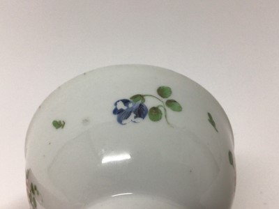 Lot 72 - A Bristol tea bowl and saucer, painted with flowers and fruits, circa 1775
