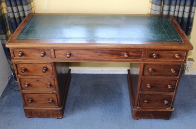 Lot 1250 - Late Victorian mahogany twin pedestal writing desk with leather lined top above an arrangement of nine drawers with bun handles, 118cm wide x 54cm deep x 67cm high