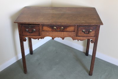 Lot 1251 - 18th century oak lowboy with three drawers above a shaped apron, on square chamfered legs, 86cm x 48cm