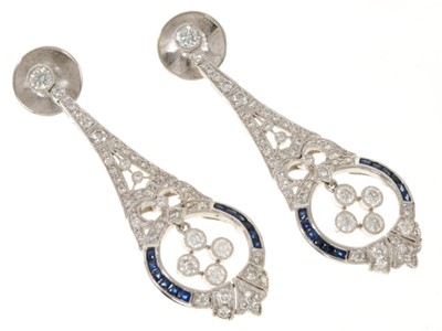 Lot 446 - Pair of Edwardian style diamond and sapphire pendant earrings, with pear shape articulated drop in 18ct white gold setting