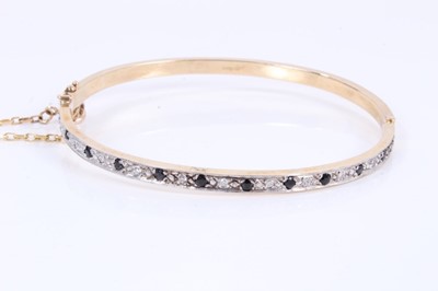 Lot 449 - Sapphire and diamond hinged bangle in 9ct yellow gold setting