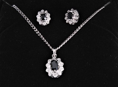 Lot 483 - Sapphire and diamond cluster pendant and matching earrings in 9ct white gold setting