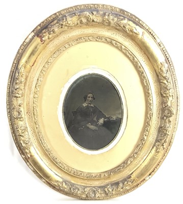 Lot 195 - Pair of Edwardian embossed brass photograph frames containing period photographic portraits, 31cm x 21cm, together with a Victorian daguerreotype in oval gilt frame (3)