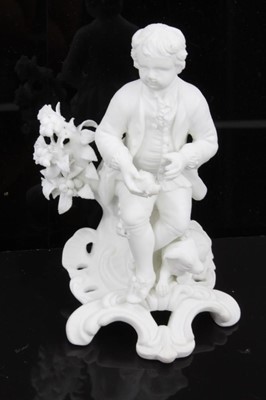 Lot 50 - A pair of Derby bisque figures of a boy and a girl, late 18th/early 19th century, shown seated on scrolled rococo bases, the girl holding a basket of fruit, the boy holding a game bird and with a h...