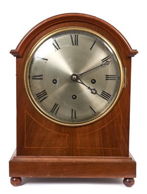 Lot 653 - Early 20th century German chiming bracket clock with silvered dial, chime/silent and eight gongs and four gongs selector to dial, in inlaid mahogany dome top case, key and pendulum present  38 cm...