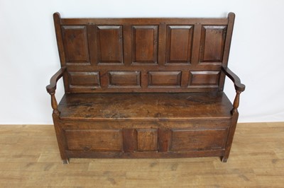 Lot 1262 - 18th century Welsh oak panelled settle, with fielded panel back and solid seat flanked by scroll arms, conforming panelled base, 135cm wide x 49cm deep x 122cm high