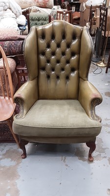 Lot 1296 - Green Leather upholstered wing armchair.