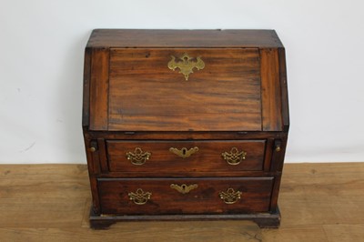 Lot 1266 - George III fruitwood apprentice bureau, with hinged slope enclosing a fitted interior, two drawers below on bracket feet, 50cm wide x 28cm deep x 49cm high