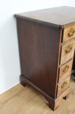 Lot 1269 - George II mahogany kneehole dressing table, the top with re-entrant angles and seven drawers and flush concealed apron drawer about the cupboard kneehole, 76cm x 50cm x 80cm