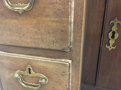 Lot 1269 - George II mahogany kneehole dressing table, the top with re-entrant angles and seven drawers and flush concealed apron drawer about the cupboard kneehole, 76cm x 50cm x 80cm