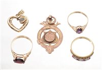 Lot 522 - Three gold and gem set dress rings, plus two...