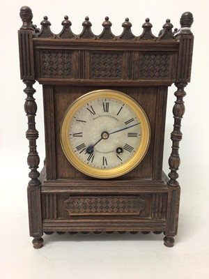 Lot 896 - Late Victorian mantel clock retailed by John Bennett, London with silvered dial , striking movement on gong signed Lenzkirch in Gothis-style oak case 35 cm high, 23 cm wide, with pendulum