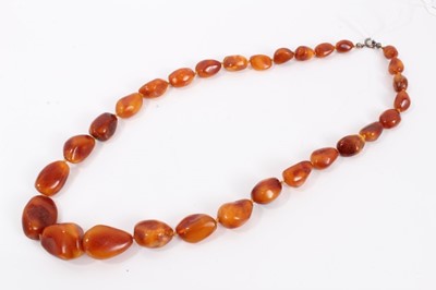 Lot 570 - Old amber necklace with a string of graduated free form butterscotch amber beads, 60cm, approximately 50.8 grams.