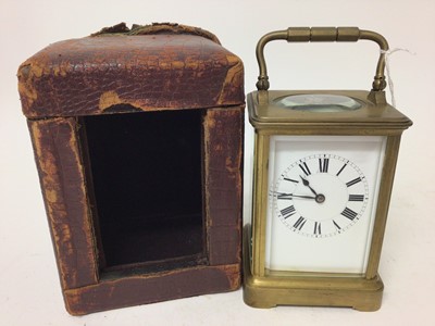 Lot 672 - Early 20th century French brass carriage clock with striking movement with gong 17cm high in leather travelling case