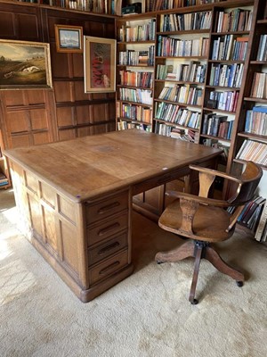 Lot 1202 - 1920s oak pedestal writing desk and revolving desk chair