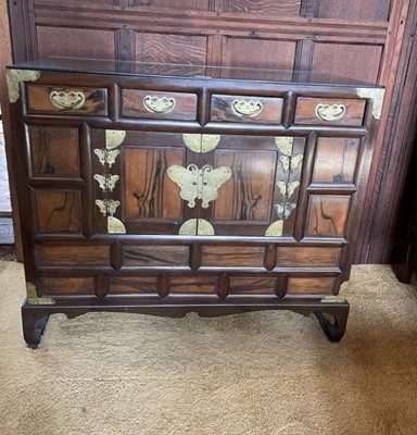 Lot 1216 - Near pair of Chinese hardwood brass mounted cabinets with an arrangement of drawers and cupboards, butterfly formed hinges, raised on scroll supports, 86.5cm wide x 41cm deep x 74cm high