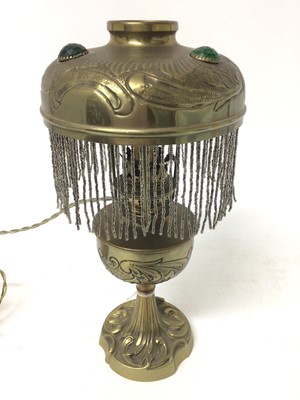 Lot 857 - Arts and crafts brass table lamp, converted to electricity, 32cm tall.