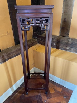 Lot 1204 - Chinese hardwood torchère of square form with pierced geometric frieze, on square legs, 33cm square x 112cm high