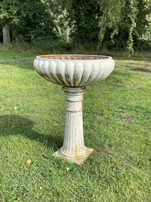 Lot 1231 - Pair antique white painted cast iron garden planters of lobed compressed form, on fluted splayed columns and sqaure plinth base, 68cm diameter