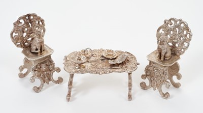 Lot 278 - Pair Continental cast white metal miniature chairs of decorative form