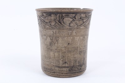 Lot 16 - An unusual antique earthenware beaker, inscribed 'PIERRE DE LA MER - MORTE', with incised foliate patterns, 8cm high