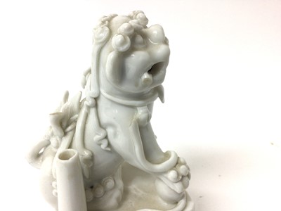 Lot 119 - A pair of Chinese blanc de chine foo dog incense burners