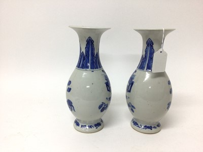 Lot 162 - A pair of 19th century Chinese blue and white porcelain vases, of baluster form, each painted with a figural scene, with foliate patterns around the neck and foot, 23cm high