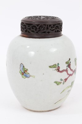 Lot 128 - A Chinese famille rose ginger jar and carved wooden cover, 18th/19th century, painted with peonies and other flowers, 13.5cm high including cover