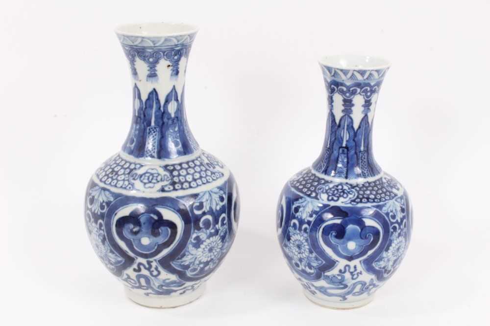Lot 34 - Two similar 19th century Chinese blue and white bottle vases, both decorated with dragons, foliate patterns, ruyi symbols, etc, marks to bases, 22cm and 24.5cm high